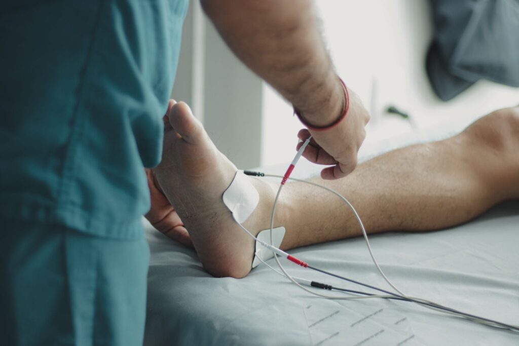 Healthcare professional examining a patient's foot at the bedside