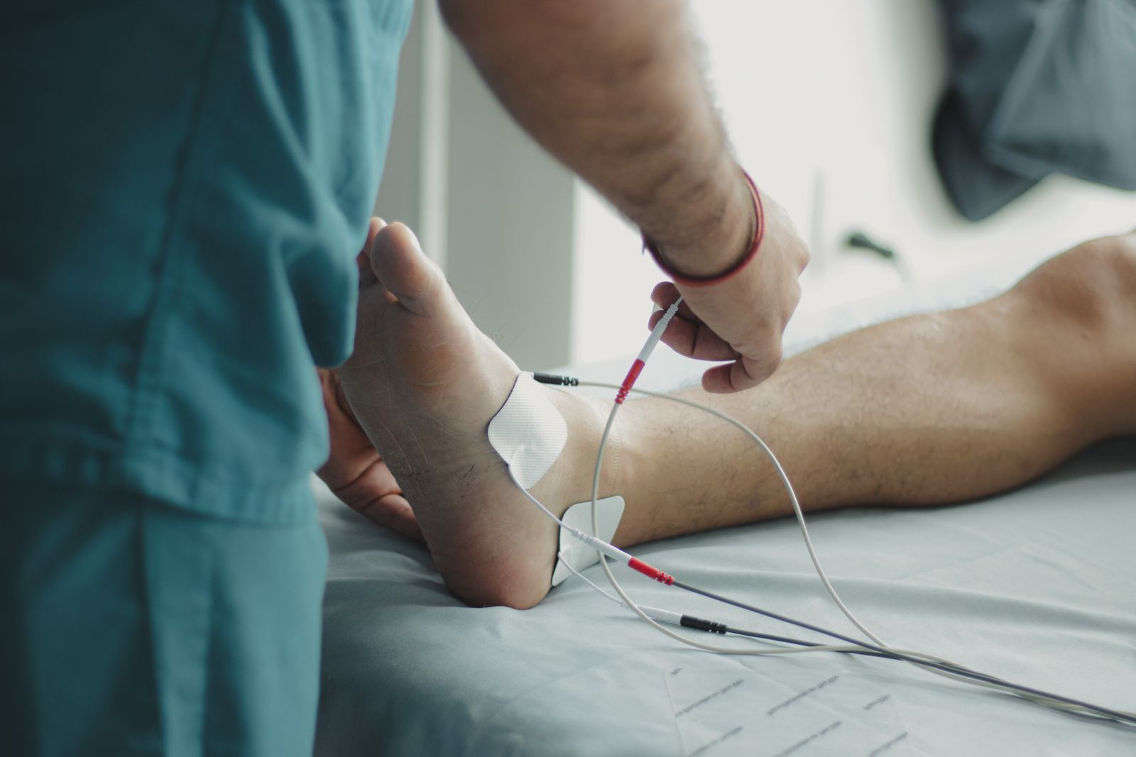 Limb salvage: a clinician examining a patient's foot at the bedside